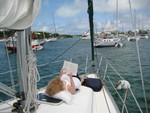 Finally a relaxing place to read book, Betty Douglas on deck of Anticipation in Hopetown Harbour