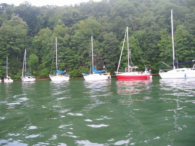 Boats line up on mooring line near dam