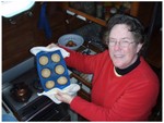 It was cold.  The boat has no heat and was especially chilly in th morning.  Adair is showing off her breakfat muffins.  The oven warms the boat up.