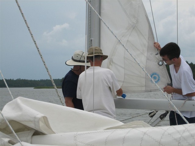 Bill Murdoch repairing blown-out sail for Matt Little