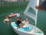 Minta learning fine points of dinghy sailing from Robert Banks..